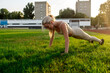 © Maria - Beautiful blonde doing exercises in training at the stadium in summer