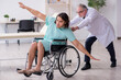 © Elnur - Young male patient in wheel-chair and experienced doctor traumatologist