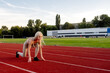 © Maria - Beautiful young blonde starts running a treadmill in the stadium
