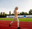© Maria - Beautiful young blonde woman runs on a treadmill in the stadium