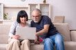 © Elnur - Old couple doing the online shopping
