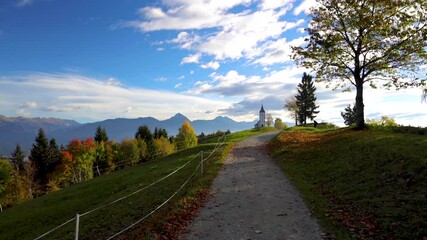 Wall Mural - Landscape of church of St. Primoz near Jamnik, Slovenia and Julian Alps at background 