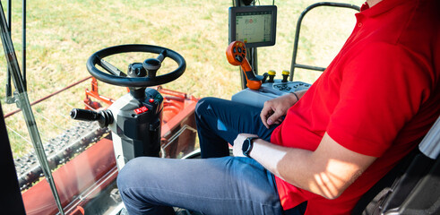 Aufkleber - Unmanned autonomous harvester on the field. View from the cockpit. The driver does not keep his hands on the steering wheel	
