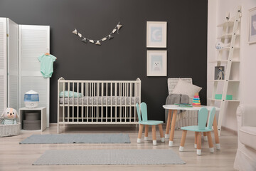 Poster - Cute baby room interior with modern crib near dark wall