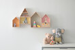 © New Africa - House shaped shelves and chest of drawers with toys in children's room. Interior design