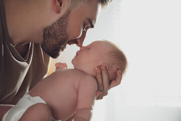 Poster - Father with his newborn son on light background, closeup