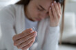 © fizkes - Frustrated young girl holding engagement diamond ring, denying marriage proposal. Stressed unhappy millennial woman suffering from relations problems, breakup relationship, betrayal divorce concept.