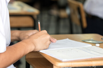 Wall Mural - student taking school exam of educational admission test in class and writing answer paper in univer