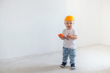 Little boy repairs in the workshop. Brigade inspector. Repairs. Development of childcare. Security expert. Future profession. Architect-builder. Kid working in a helmet.
Child in a protective helmet. 