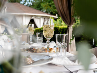 Glasses of sparkling wine on the table in an outdoor restaurant.