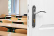 © New Africa - Wooden door open into modern empty classroom