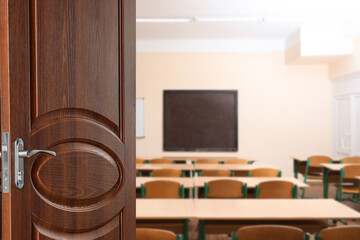 Wall Mural - Wooden door open into modern empty classroom