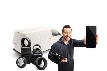 Wall Mural - Auto mechanic with a white van holding a mobile phone