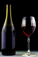 wine bottle and glass on black background