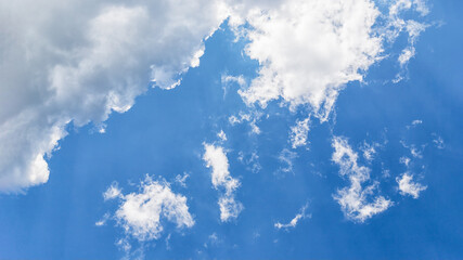 Wall Mural - Beautiful white fluffy clouds on a blue sky background, panorama