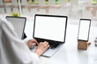 © Prathankarnpap - Cropped shot woman typing mockup laptop and empty screen of smartphone.