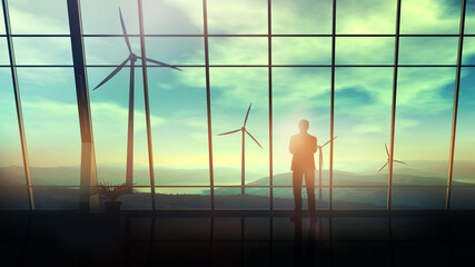 Wall Mural - in a spacious office against the window, a man looks at wind farms.