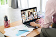 © tonefotografia - Young Woman is working with her computer screen while business meeting through video conferencing application