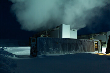 Night view. Thermal power plant building at a hot spring. Icelandic industry