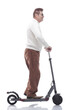 © ASDF - in full growth. casual adult male with electric scooter.