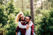 © simona - Happiness and cheerful people concpet with joyful couple playing and having fun together in the wood country side - adult man and woman in relationship carrying and laughing a lot together outdoor