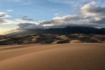  Mountain Peaks Hide in Clouds Above Sand Dunes