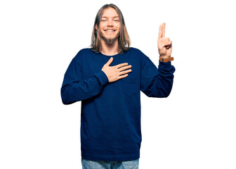 Wall Mural - Handsome caucasian man with long hair wearing casual winter sweater smiling swearing with hand on chest and fingers up, making a loyalty promise oath