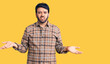 © Krakenimages.com - Young hispanic man wearing casual clothes clueless and confused with open arms, no idea concept.