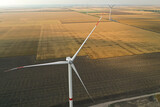 Fototapeta  - Modern windmill in field, space for text. Energy efficiency