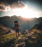 Fototapeta Na ścianę - Man traveler hiking alone in breathtaking landscape of austrian Mounatins at sunset. Travel Lifestyle wanderlust adventure concept. Outdoor wilderness vacations.