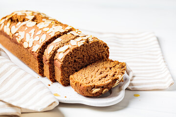 Wall Mural - Sliced banana bread, close up, white background.  bread on white board, white background.