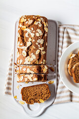 Wall Mural - Sliced banana bread on white board, white background, top view.