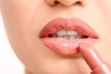 Sticker - Young woman applying makeup, closeup