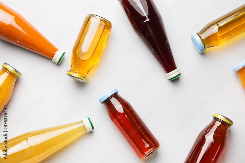 Bottles of juices on light background