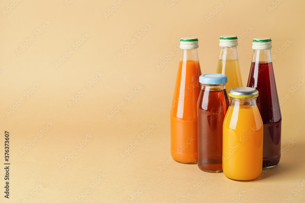 Bottles of juices on color background