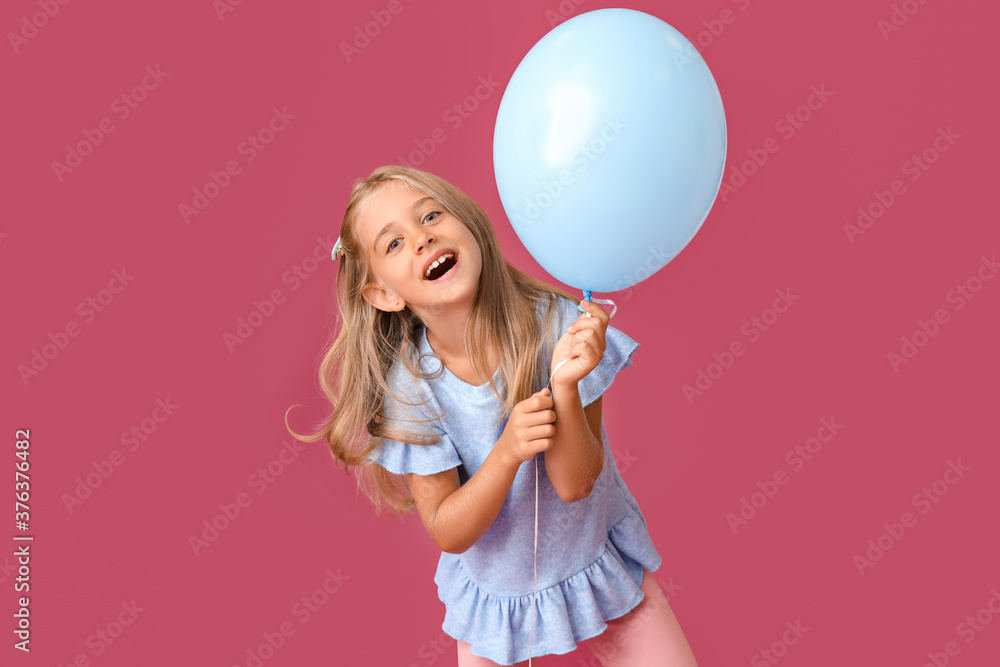 Little girl with balloon on color background