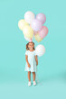 © Pixel-Shot - Little girl with balloons and birthday hat on color background