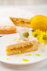 Poster - A piece of pie with lemon curd filling, decorated with flowers. Vertical photo.