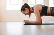Woman pushing through a painful plank