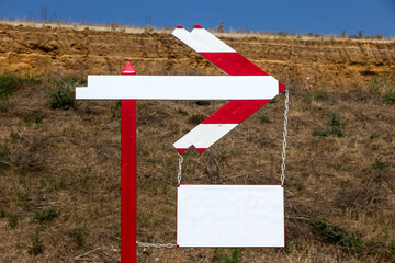 Wooden road sign on the road. Pedestrian route arrow sign direction sign. A wooden arrow indicates the route of movement with a place for an inscription. Follow the wooden arrow. Direction of arrow