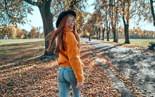 Woman In Park In Autumn