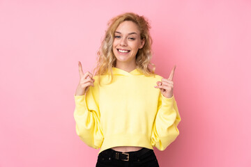 Poster - Young blonde woman wearing a sweatshirt isolated on pink background pointing up a great idea