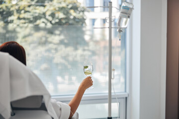 Wall Mural - Female with a glass of beverage undergoing a medical procedure