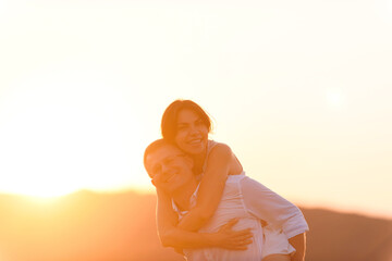 Wall Mural - woman hugging man in sunlight