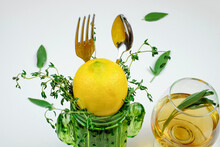 Healthy Eating Concept, Spoon And Fork In Green Glass With Rosemary And Glass Cup Of Herbal Tea On White Background