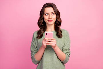 Wall Mural - Portrait of thoughtful inspired girl use smart phone want write blog post decide what subject choose look copyspace think thoughts wear jumper isolated over pastel color background