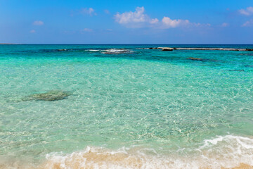 Wall Mural - Beautiful beach with crystal clear blue waters against blue sky