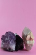 minerals and rocks placed on a pink background
