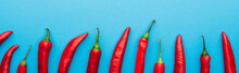 Top View Of Spicy Red Chili Peppers On Blue Background, Panoramic Shot