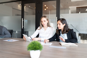 Wall Mural - Female professionals working together in office